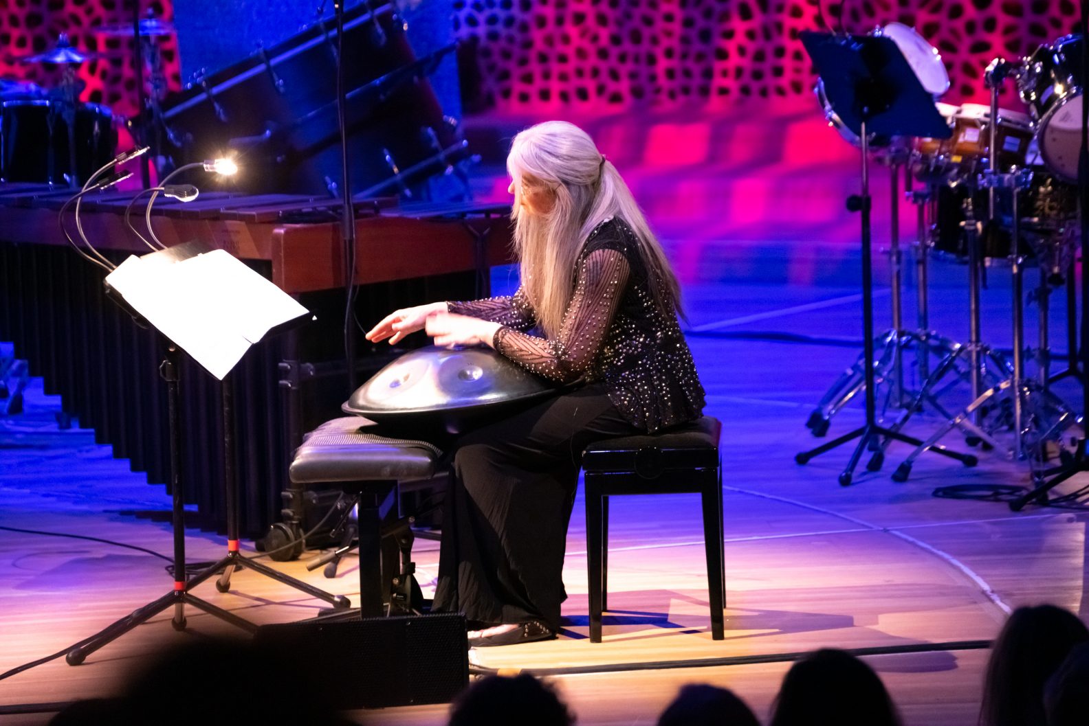 Evelyn playing at her concert. Holding an instrument