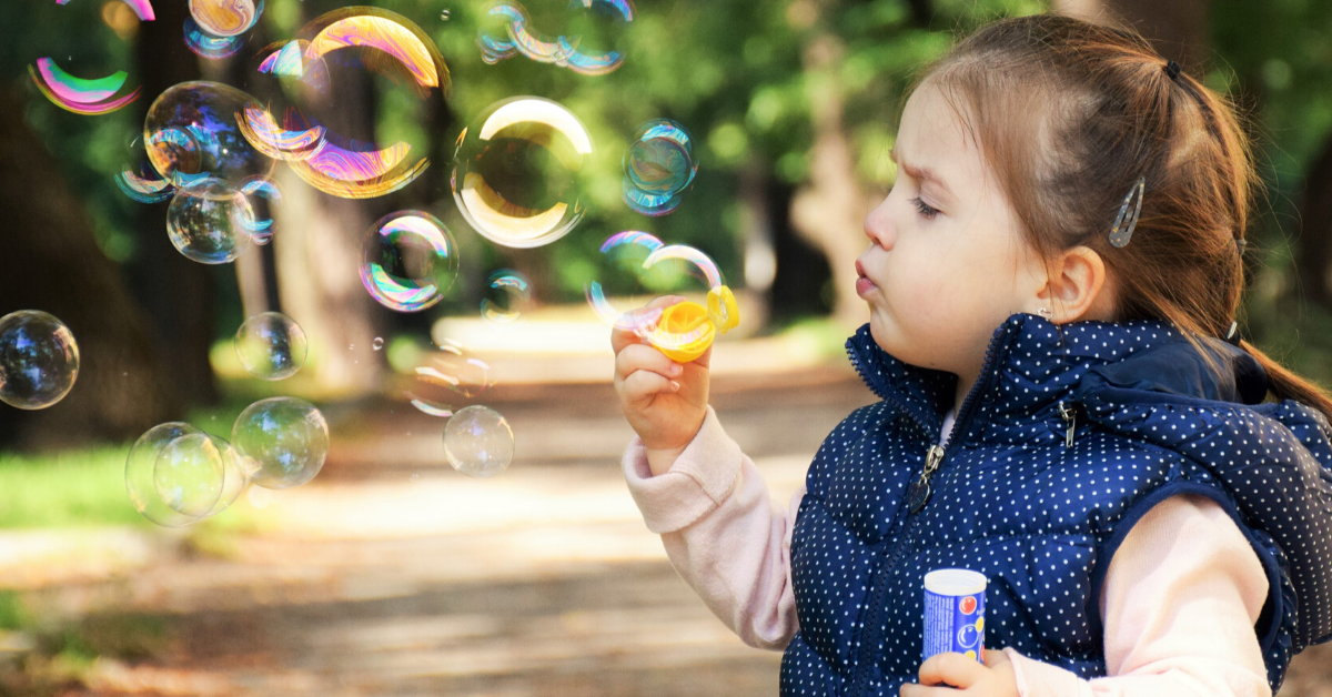 a child blowing bubbles