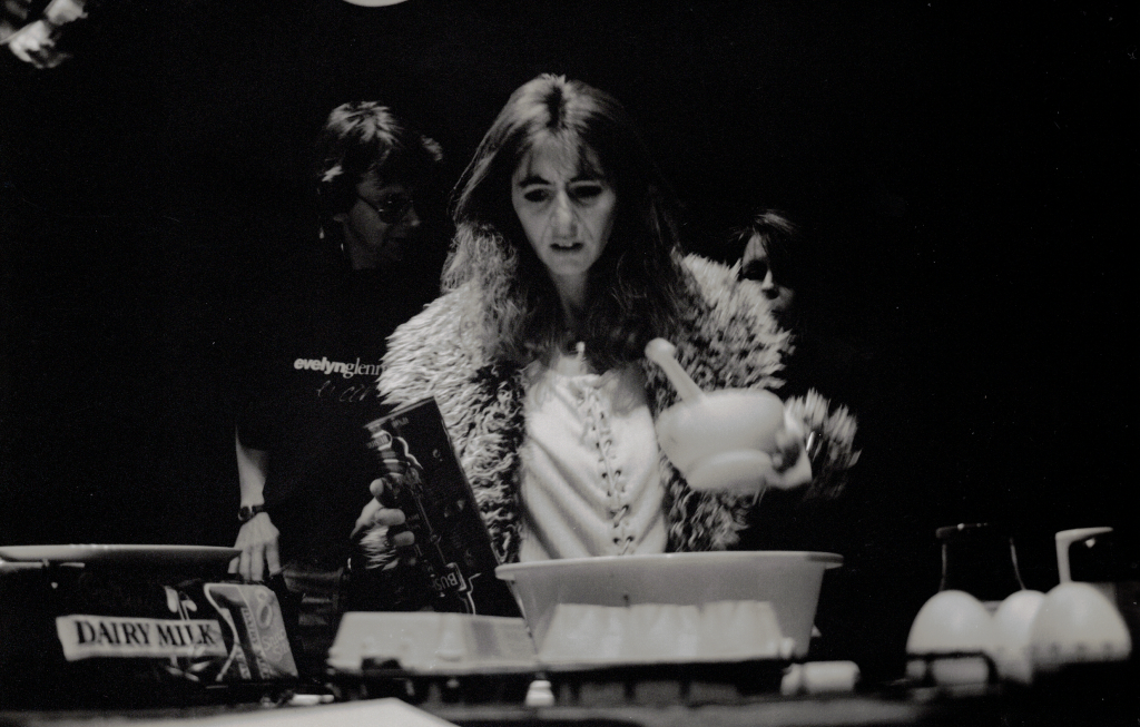 A black and white photo of Evelyn playing kitchen implements