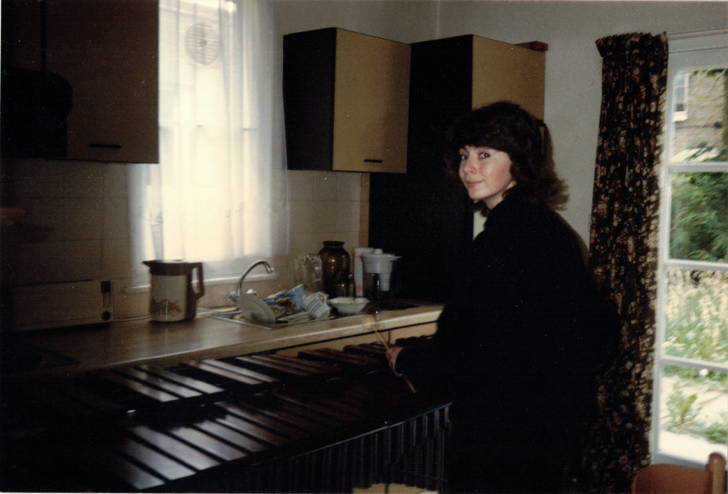 Evelyn in her London flat, playing her Marimba in the kitchen, in the 1980s