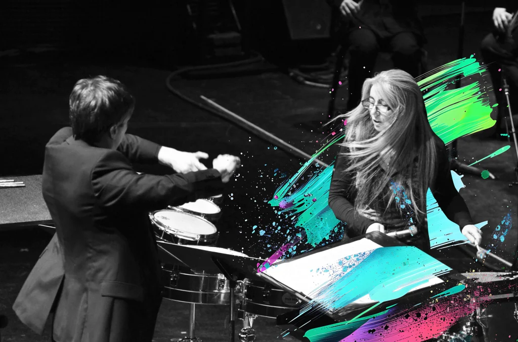 Evelyn Glennie performing live with colourful flair decorating the image