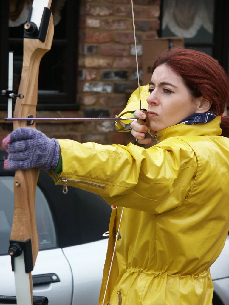 Evelyn trying her hand at archery, during the filming of Touch the Sound, in Cambridgeshire, UK